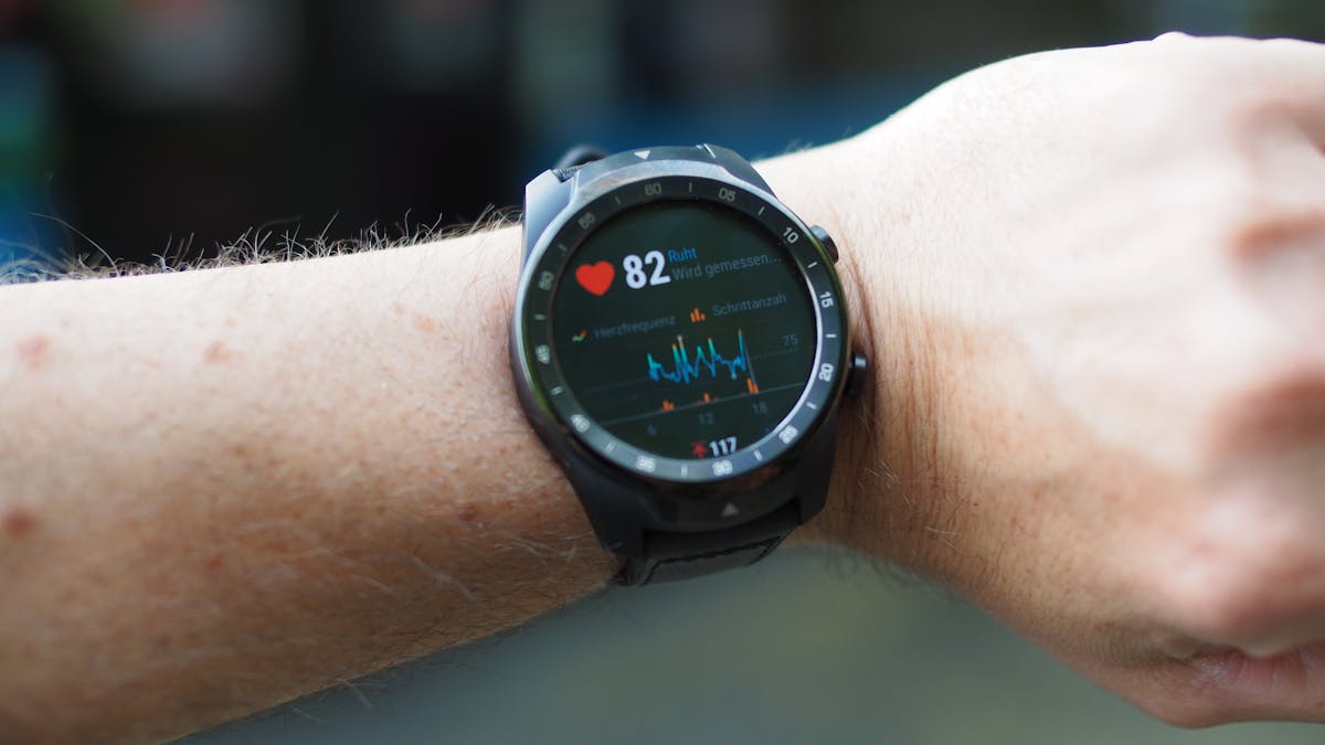 Runner checking heart rate on a fitness smartwatch